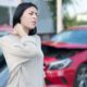 Injured woman feeling neck pain after car crash