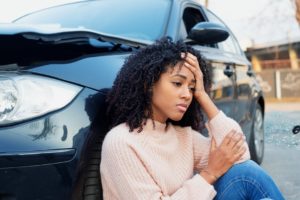 Black woman feeling pain after car crash