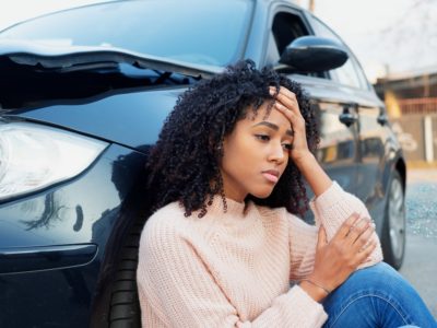 Black woman feeling pain after car crash