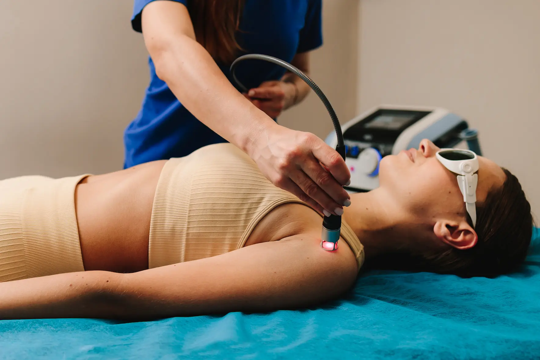 woman having laser therapy session for shoulder pain
